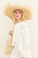 Straw Hat with Tassels and Eyelet Detail